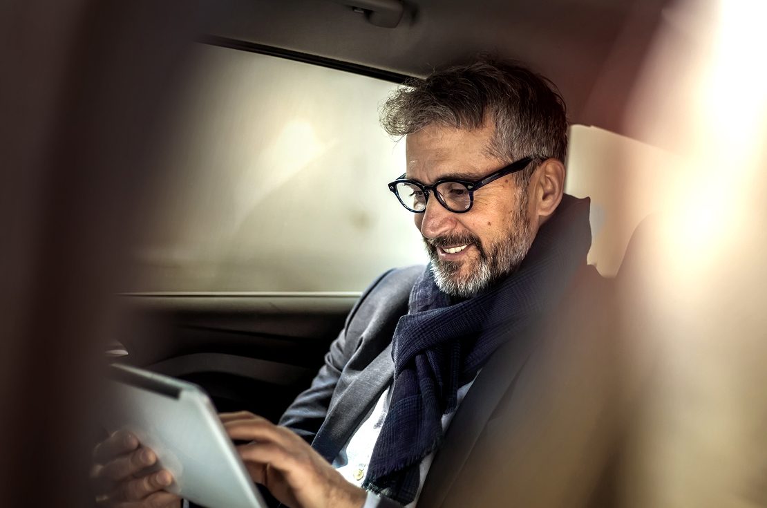 Man in car with tablet